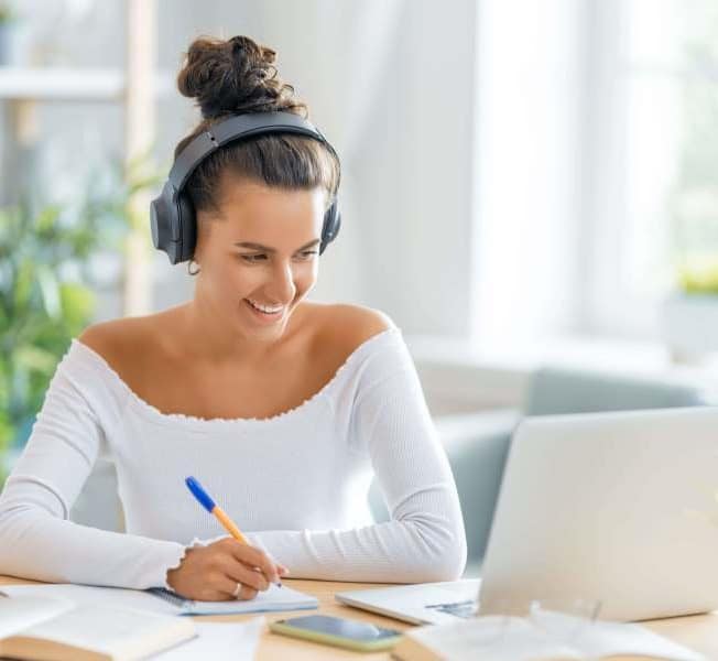 Student with headphones having an online tutoring lesson